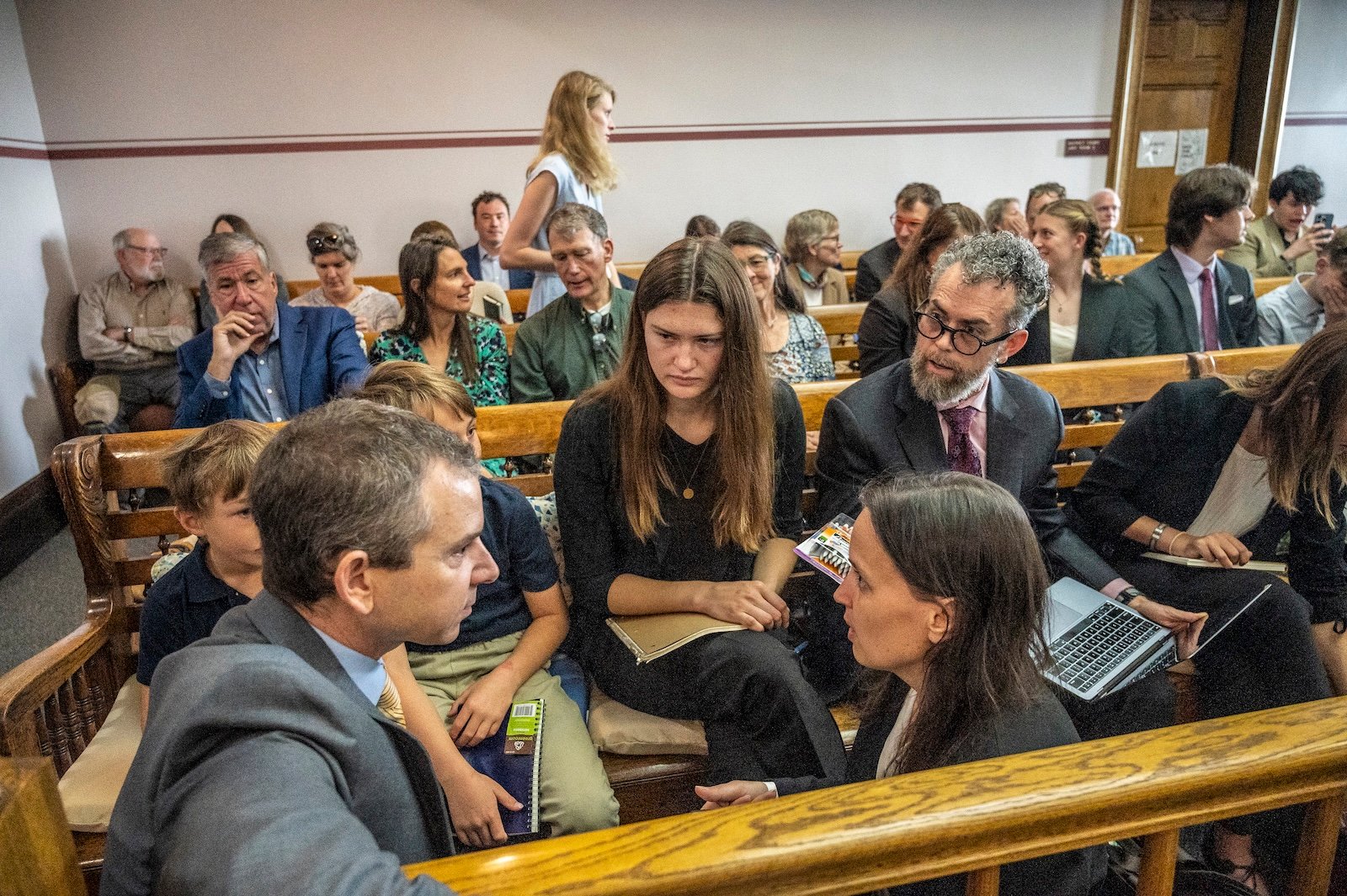 Young plaintiffs confer with their lawyers in a courtroom in Montana.
