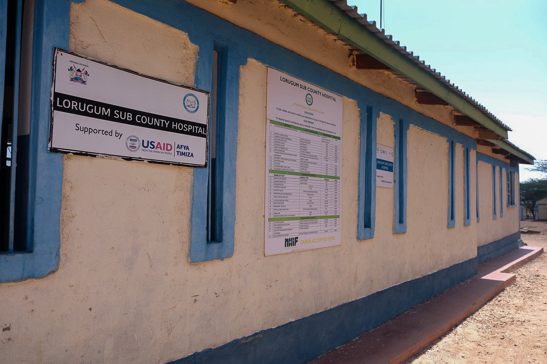USAID signs hang on a one-story building in a rural rea