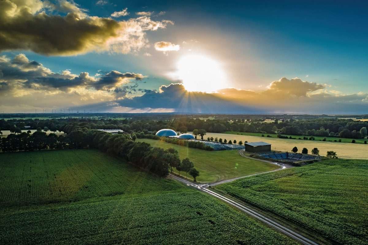 Biogas domes in a field with sunny sky