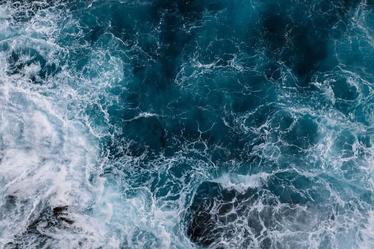 Wave-strewn and chaotic surface of the ocean as seen from directly above and at some height