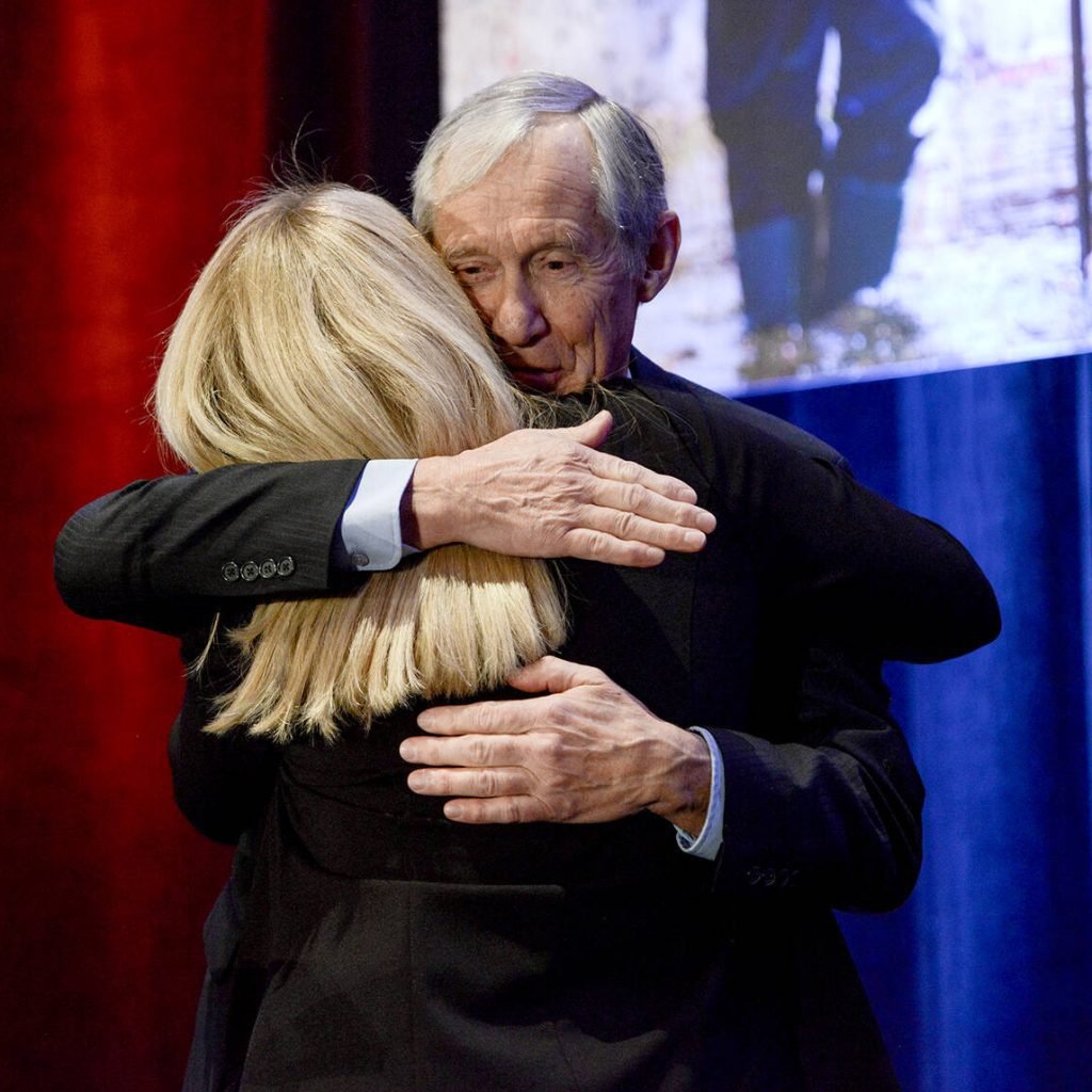 Crispin Colvin hugs Tracey Arts after being recognized for nine years of board service at the Ontario Federation of Agriculture's annual general meeting in Toronto on Nov. 26, 2025. Photo: Diana Martin