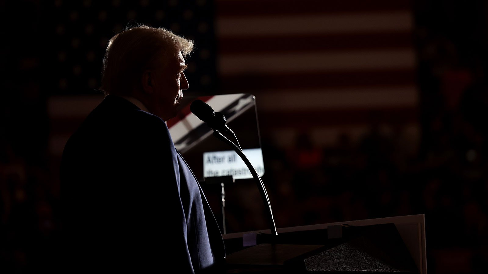 Donald Trump giving a speech at a podium