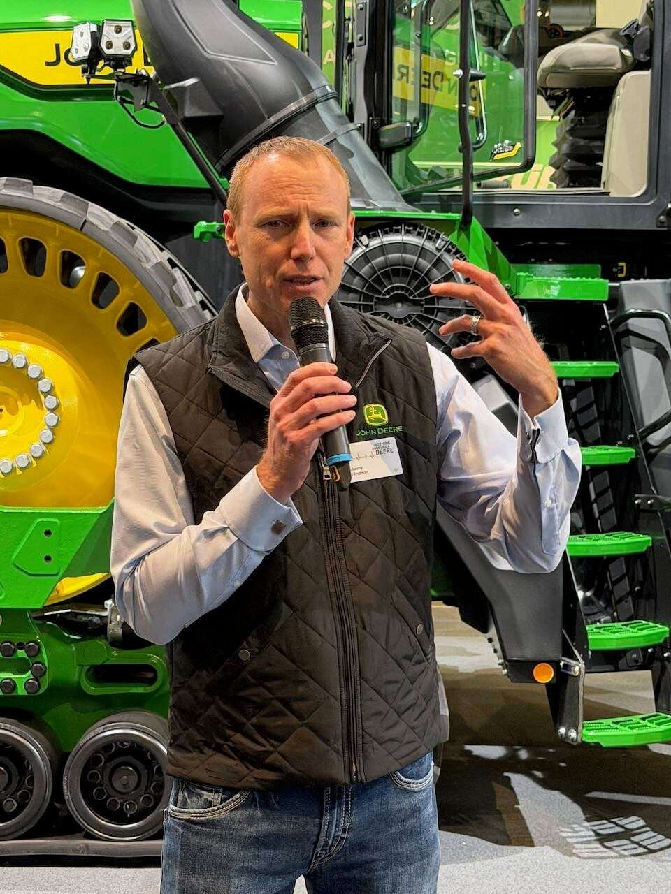 Jahmy Hindman of John Deere talked about the autonomous 9R tractor behind him at Agritechnica 2025. Photo: John Greig