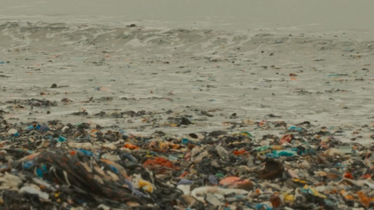 Textile waste washed up on the beach in Accra, Ghana