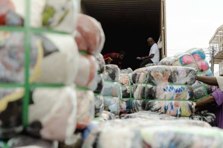 Secondhand clothing bales being offloaded off the shipping trucks at the Importers yard in the Kantamanto Market