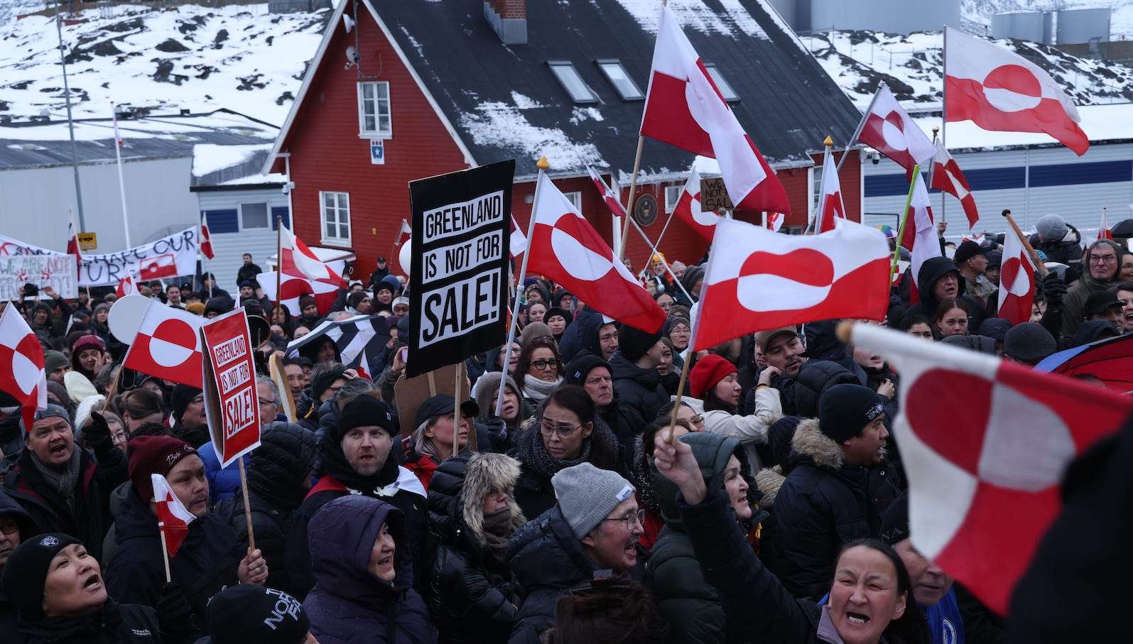 People bear Greenlandic flags as they gather in front of the U.S. consulate protest against U.S. President Donald Trump and his announced intent to acquire Greenland on January 17, 2026 in Nuuk, Greenland.