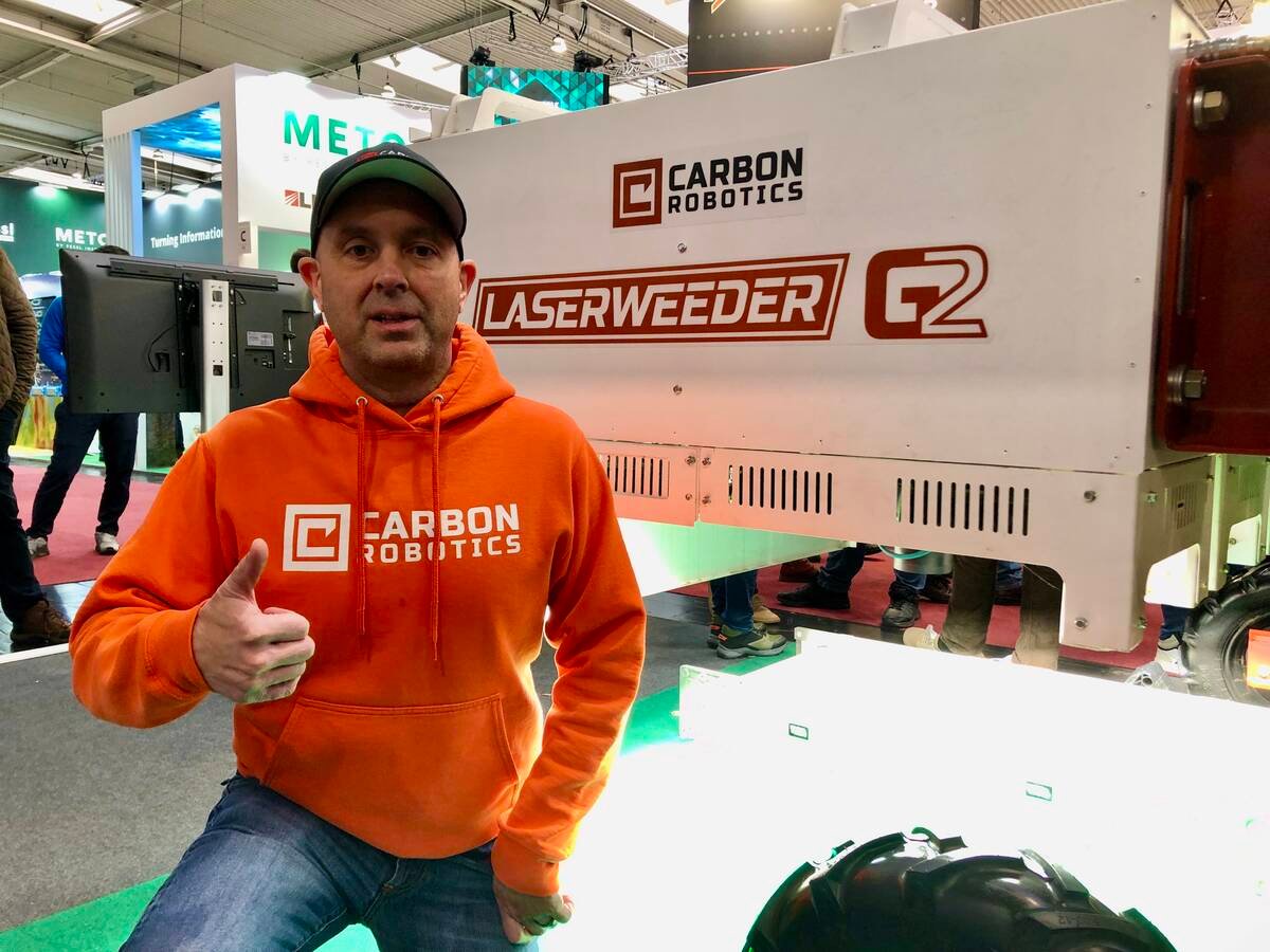 Paul Mikesell, chief executive officer and founder of Carbon Robotics, stands beside the LaserWeeder G2 at Agritechnica.
