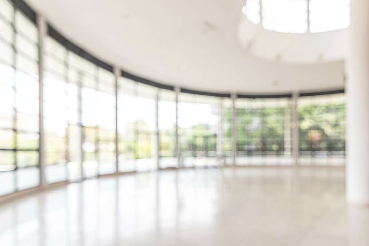 Office foyer - a modern, circular perimeter space with large windows and white flooring