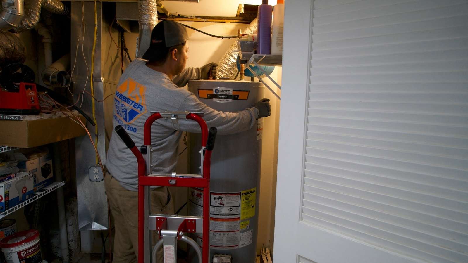 A technician at heating, cooling and plumbing company John G. Webster, removes a gas water heater from a home in Washington, DC, on August 28, 2024.
