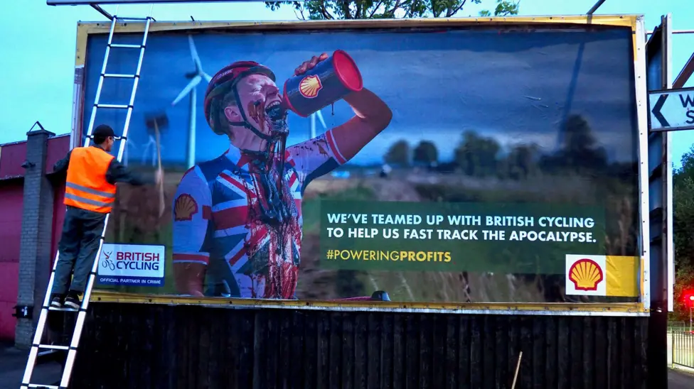 a subvertising billboard aimed at Shell's greenwashing sponsorship of British Cycling