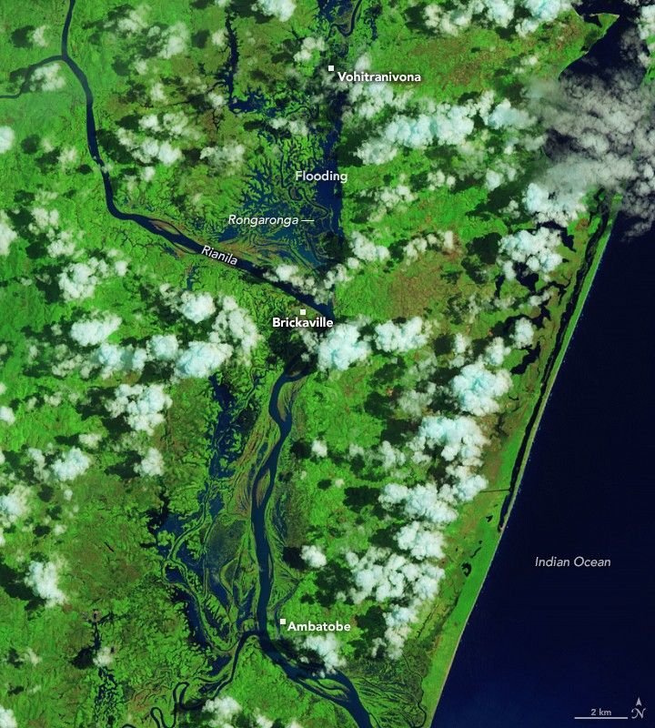 In a false-color image acquired after the flooding, waterways appear much wider, and floodwater covers large portions of the landscape west of the two rivers, both north and south of Brickaville.