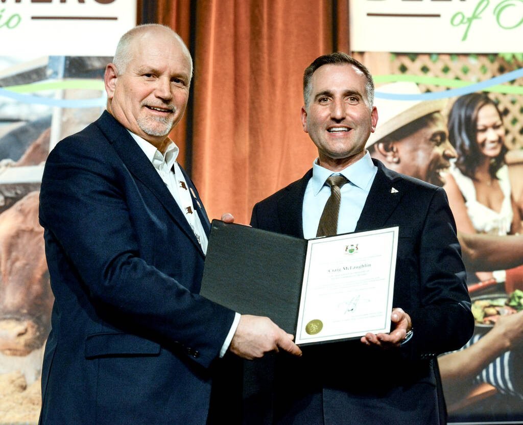 Trevor Jones, Ontario Minister of Agriculture, Food and Agri-business, right, presents Craig McLaughlin, outgoing president of Beef Farmers of Ontario, left, with a certificate recognizing his contributions to the sector at BFO's annual general meeting gala in Toronto on Feb. 18, 2026. Photo: Diana Martin