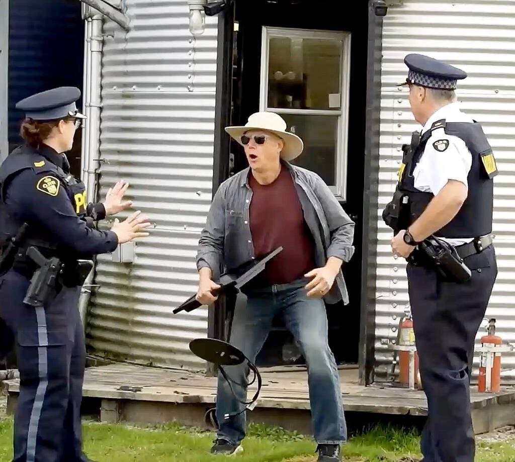 Sgt. Jill Johnson of OPP West Region’s Crime Prevention and Community Support Bureau, left,  and Auxiliary Inspector Brad Hull, OPP West Region regional commander, right, catch a "thief" in the act during an OPP video discussing various steps rural property owners can take to protect their property as part of the Grey Bruce Farmers Week On-Demand session in early January.  Screengrab Image. 