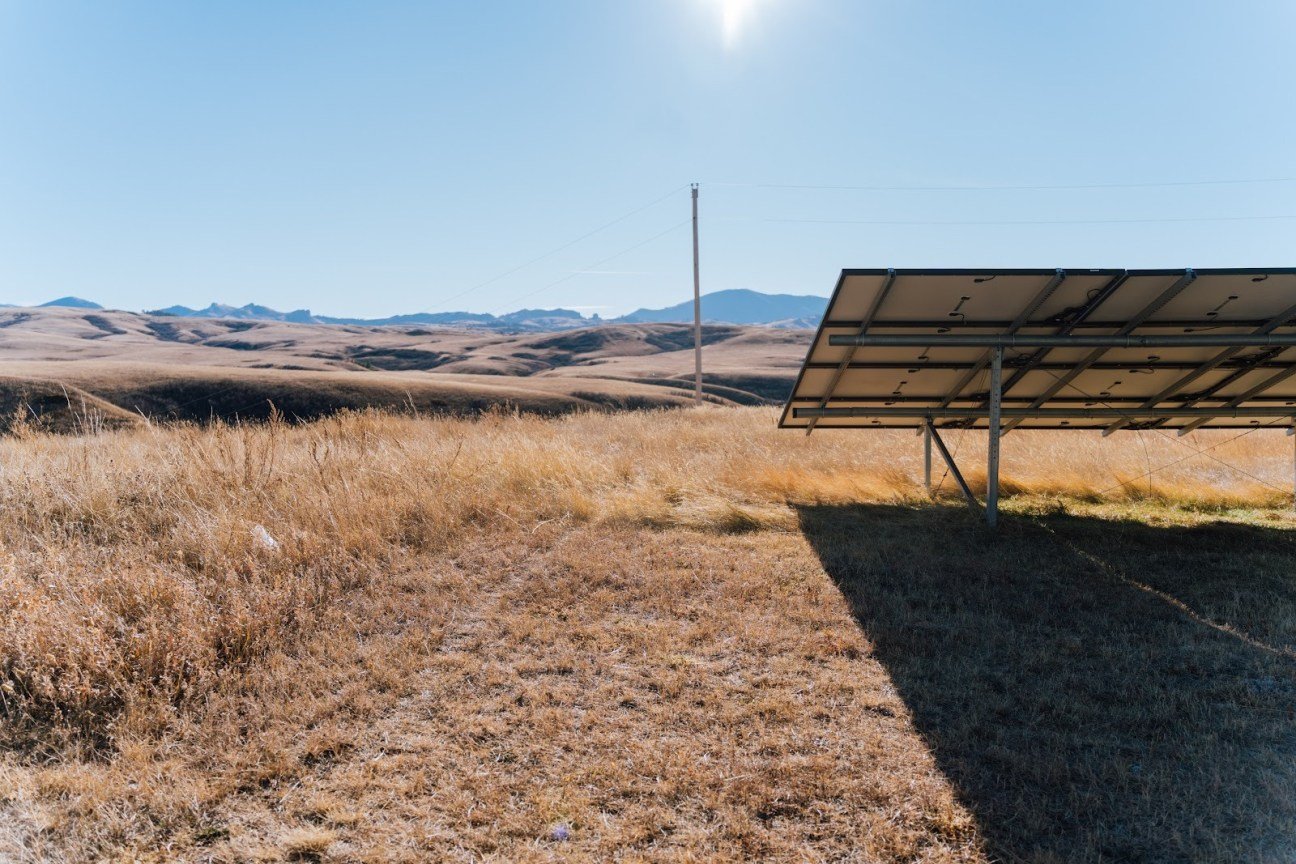 Solar panels sit on the prairie