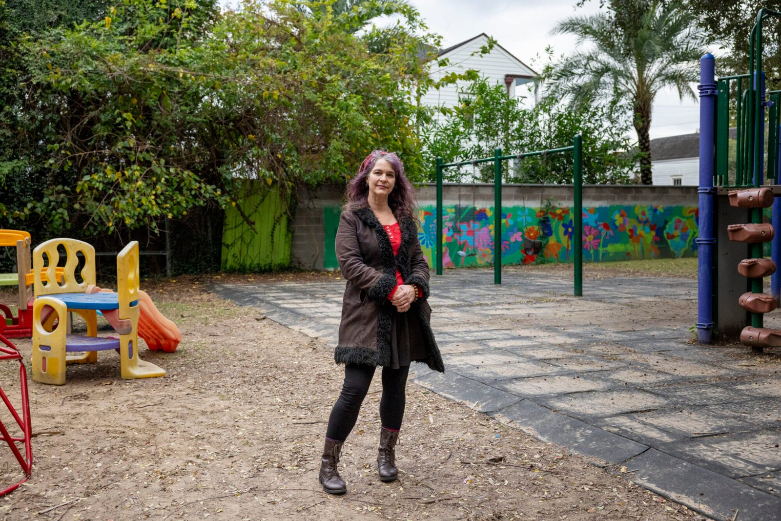 A woman stands in a playground