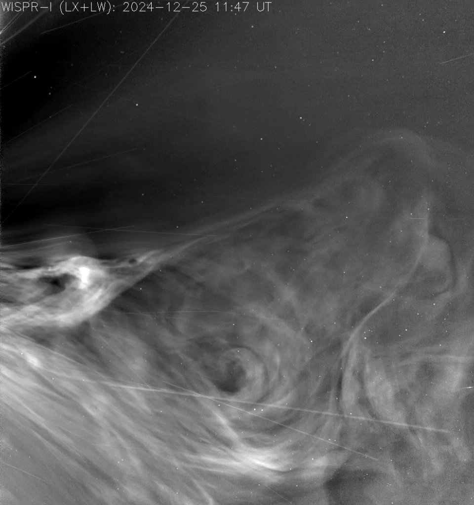 Image of solar wind racing out from the Sun’s outer atmosphere, looking like smoke on a black background.