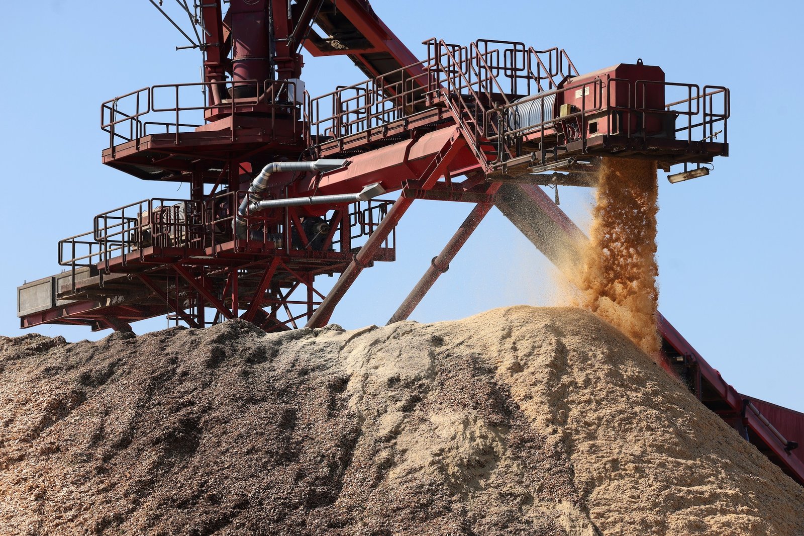 a large piece of equipment shreds wood, generating dust