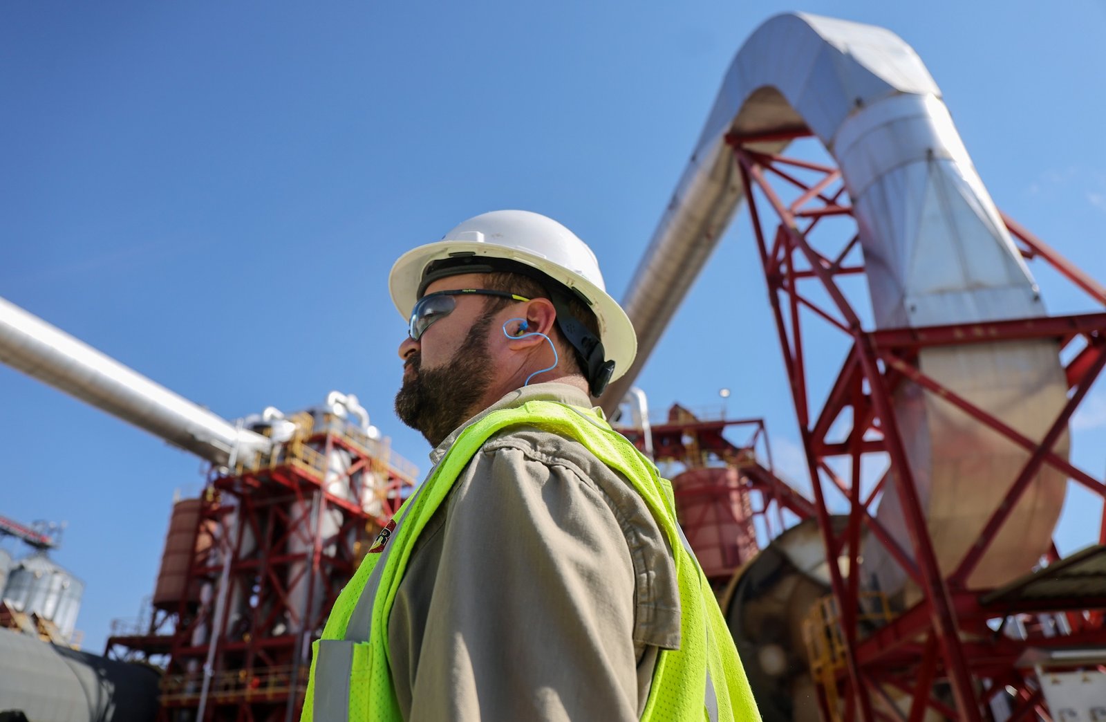 a worker at a wood pellet facility looks up