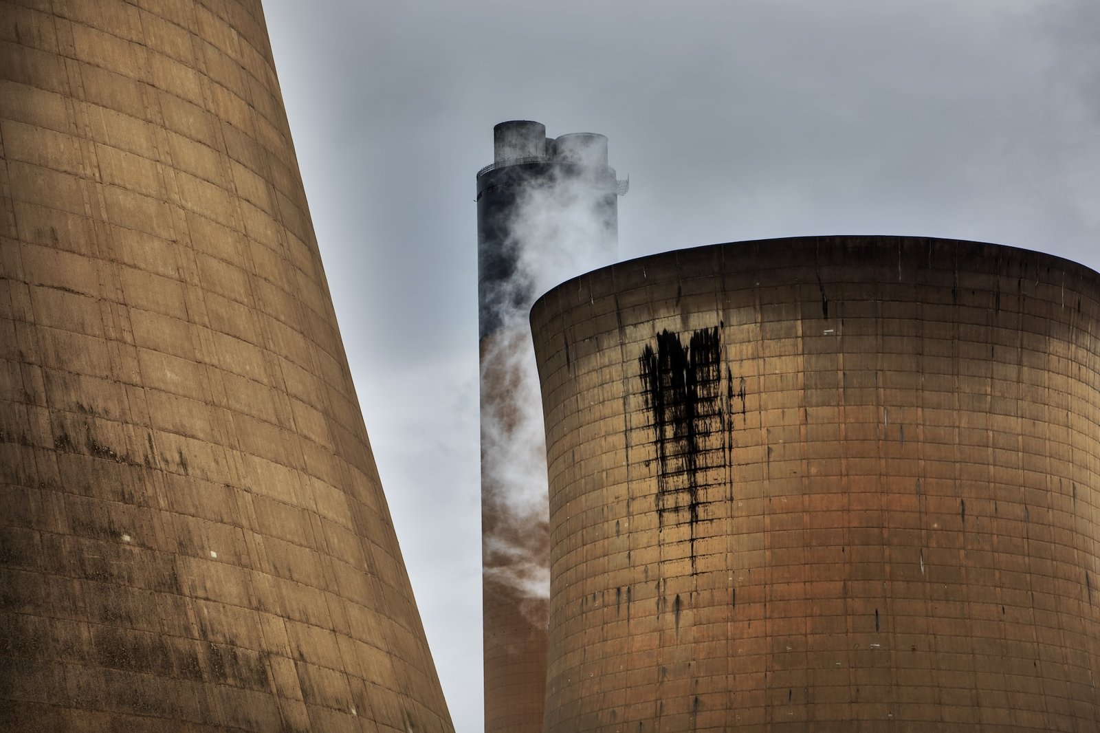 smoke escapes a large smoke stack