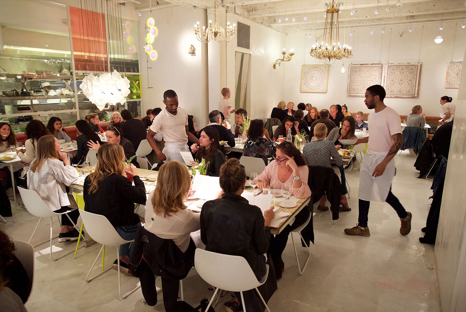 Servers walking through crowded dining room