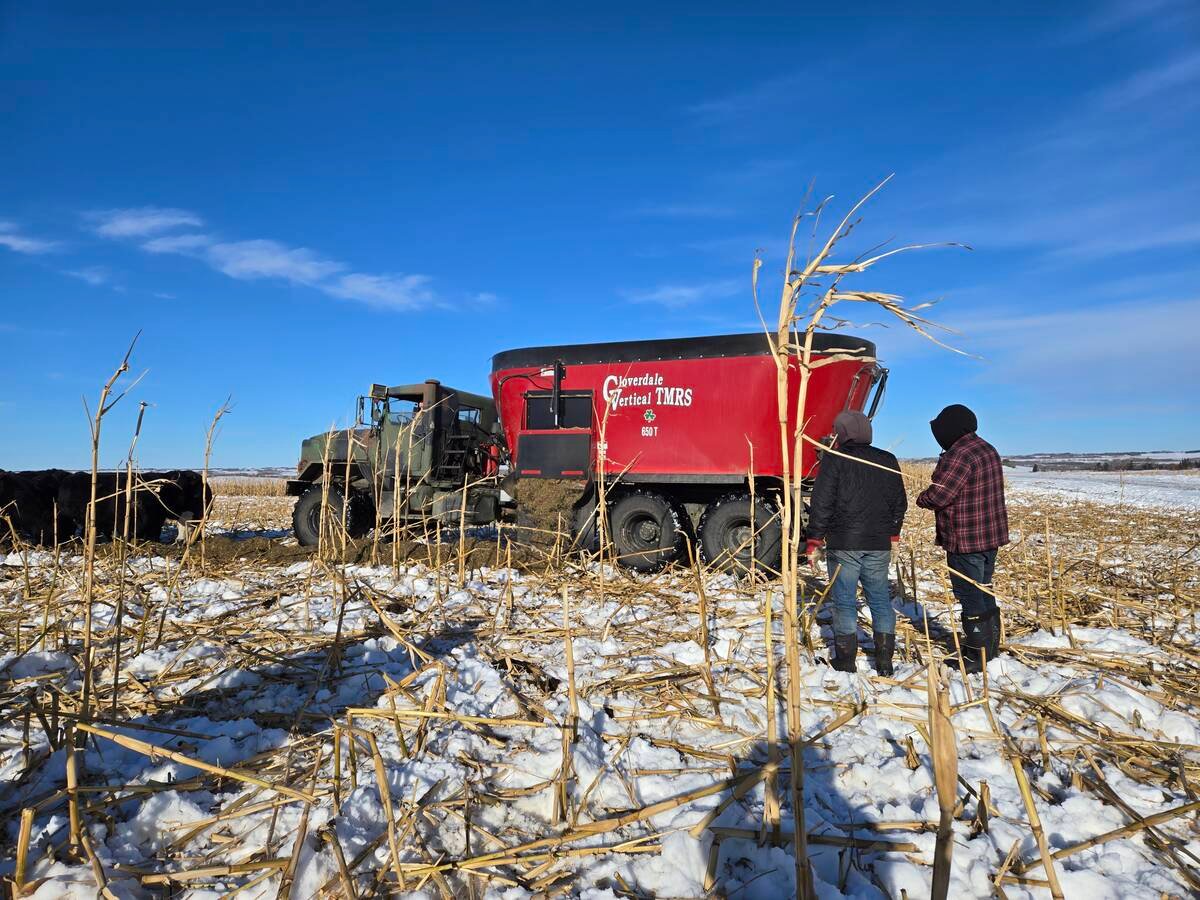 Participants at a winter grazing tour on Bos Family Farms near Rapid City, Man., check out “Mad Max,” the feeding truck and ration mixer on Jan. 12, 2026. Photo: Miranda Leybourne