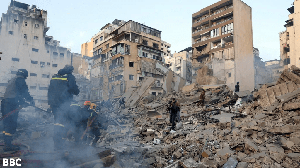Emergency personnel search through the rubble of a collapsed building after an Israeli airstrike on a residential area in Beirut, as the scale of destruction and human toll continues to unfold.