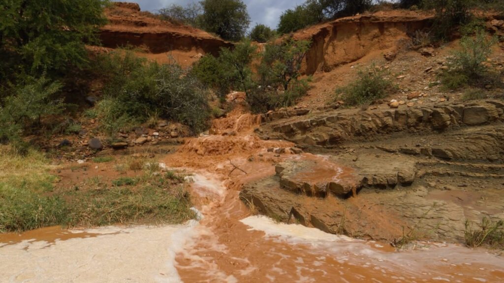 A rush of water spills down an embankment at Roam Ranch