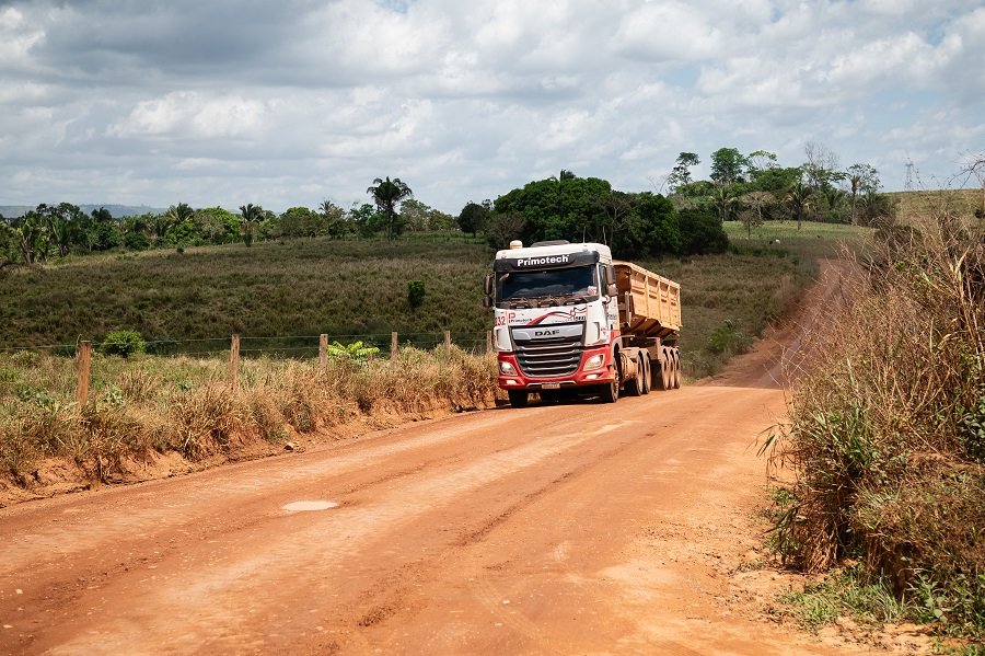 A truck drives down a dirt road