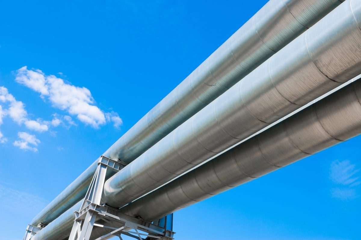 pipeline with blue sky overhead serving as backdrop