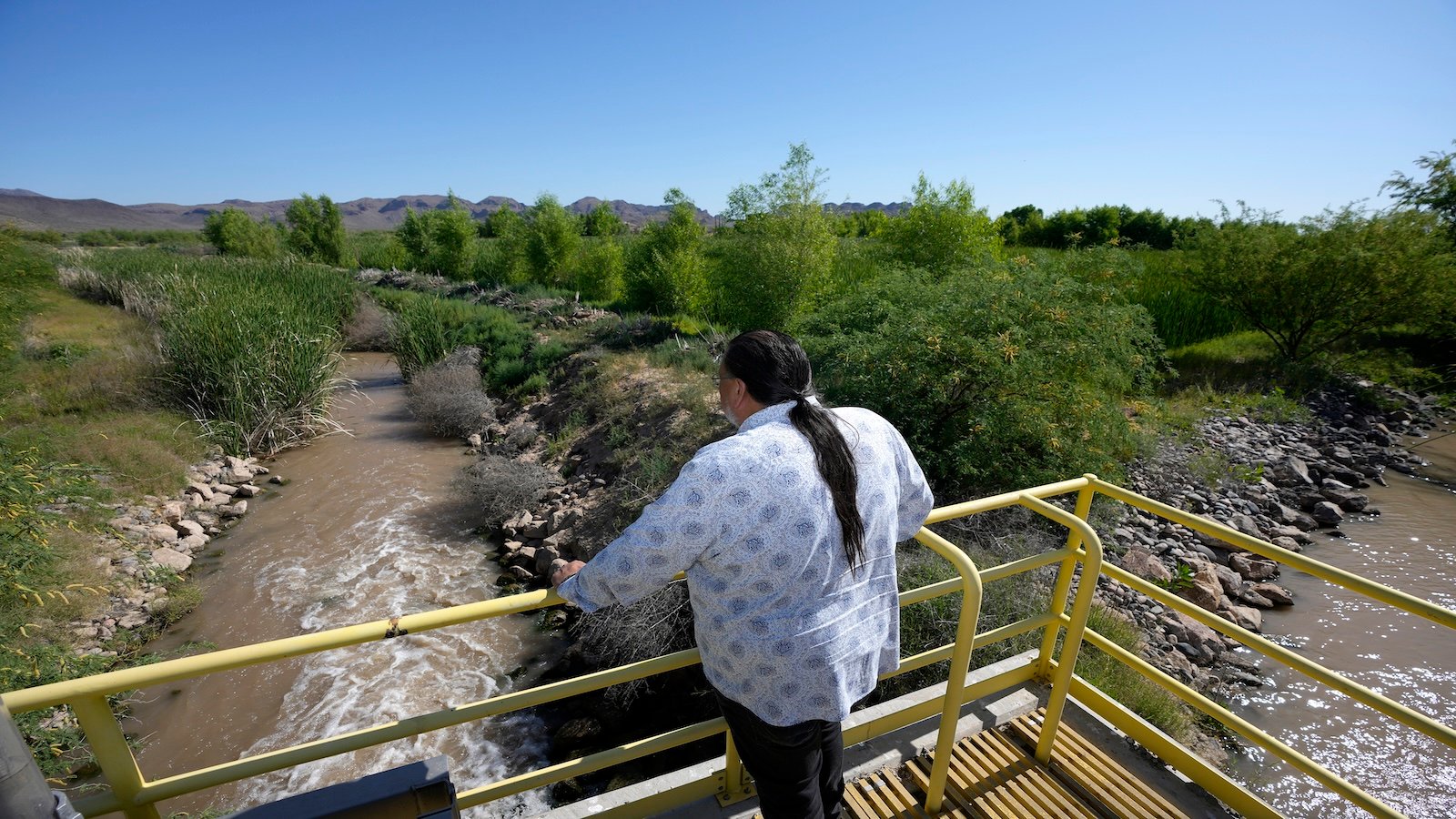 Man stands over river