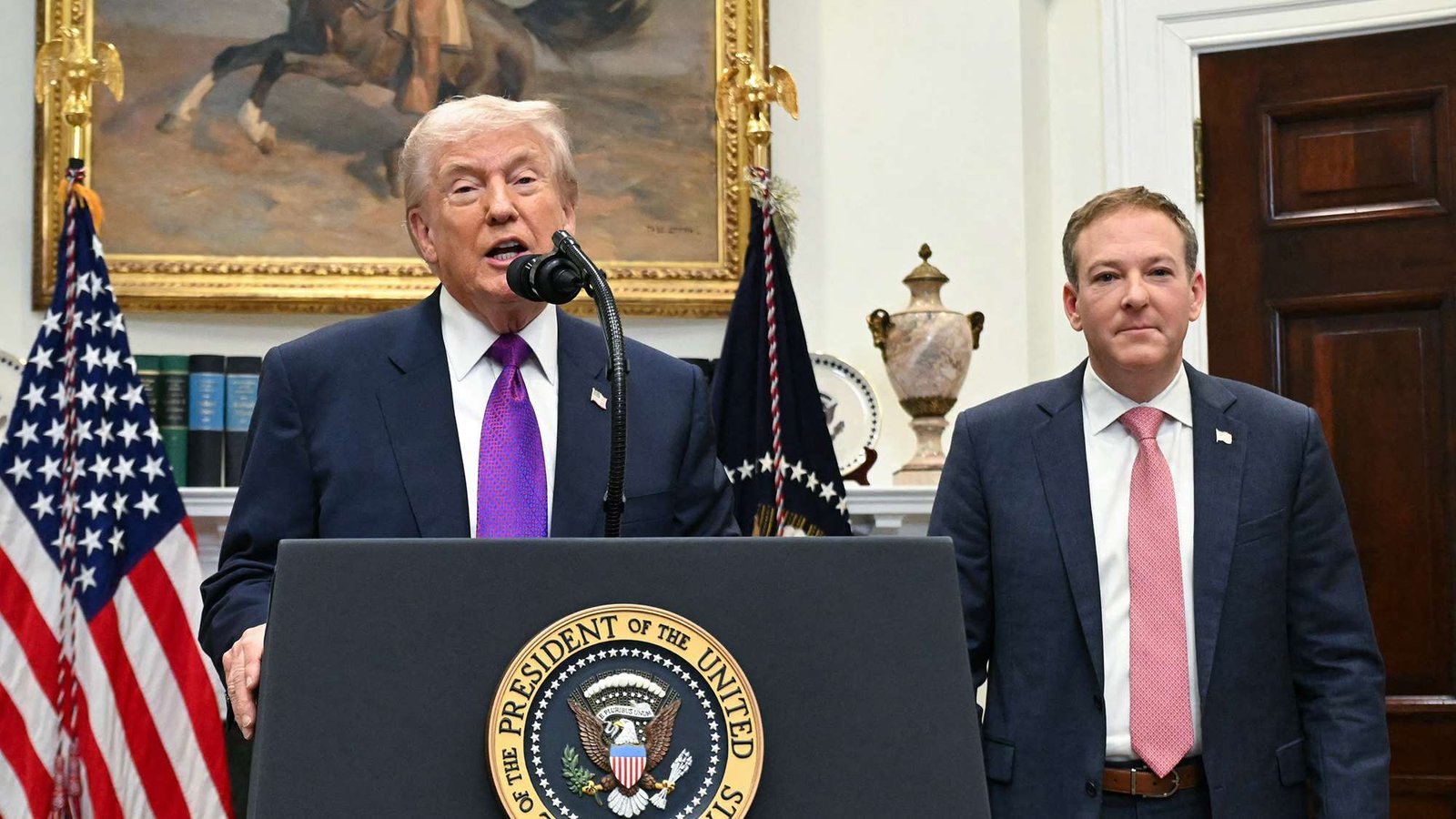 President Donald Trump and Lee Zeldin stand in front of a podium at the White House