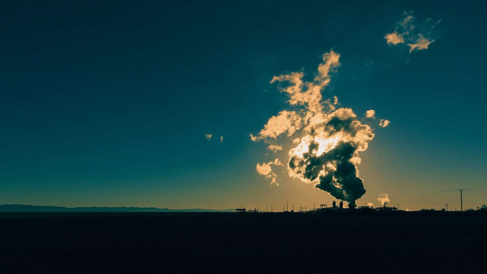 Sunlight glows through the steam of a geothermal power plant in Niland in California.