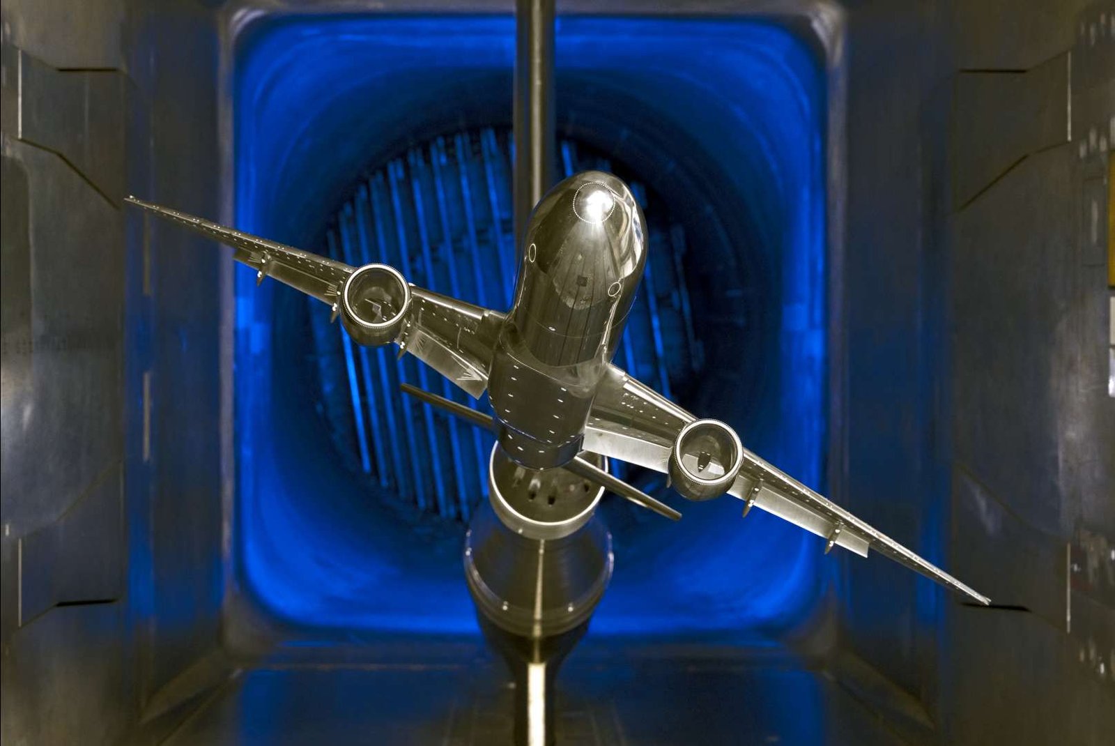 A scale model of a silver jet airliner with two engines is tested in a wind tunnel, part of the TTT available resources.