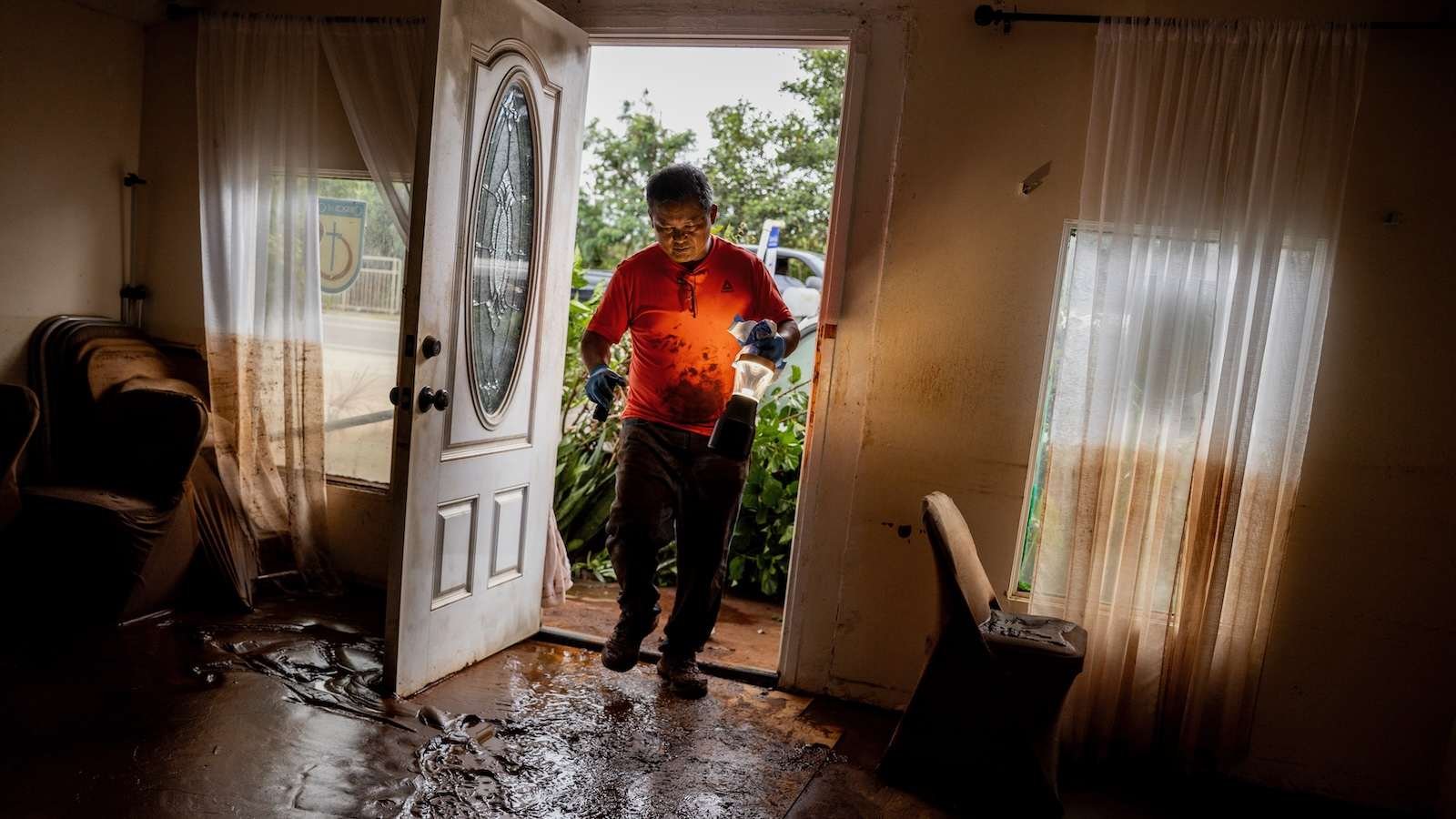 Glenn Duquez, associate pastor at Church of God Jesus is Alive Fellowship, begins to clean up after a fast-moving flood swept through Haleiwa, Hawai'i, on March 21.