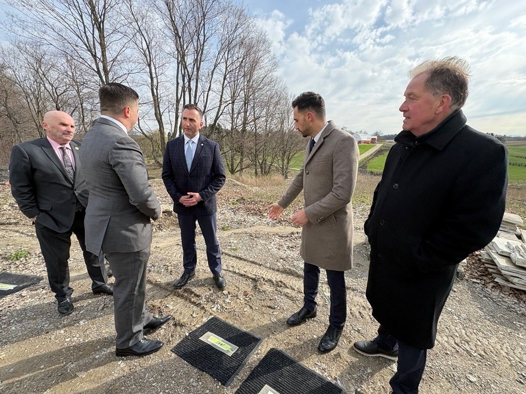 MPPs talk with Jay Willmot, CEO of Haven Greens, during the King City announcement on restrictions to foreign ownership of Ontario farmland on a farm in Ontario. Photo: Diana Martin.