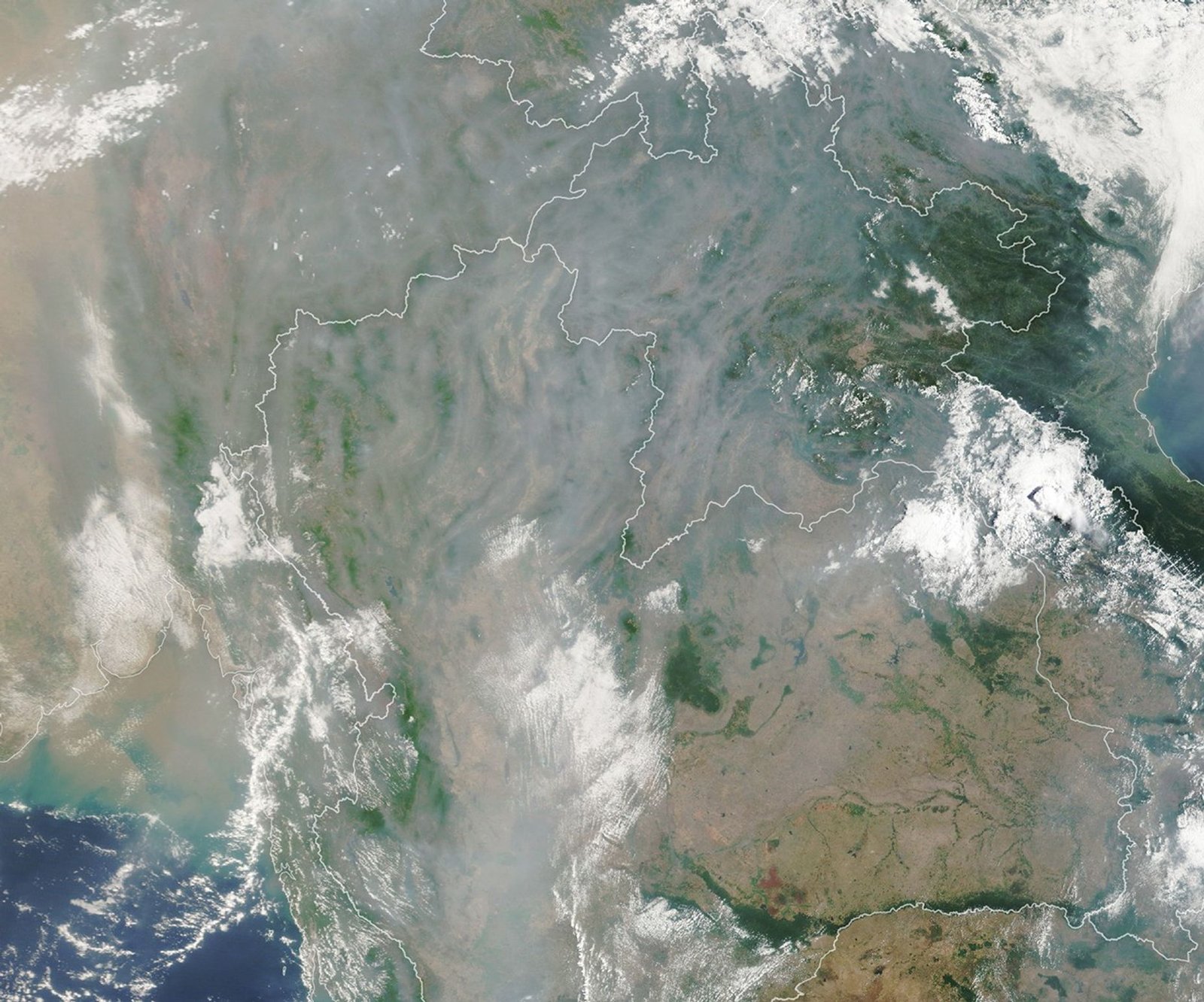 A satellite image shows gray smoke obscuring most of the landscape around Chiang Mai except for small areas where mountain ridges are visible.