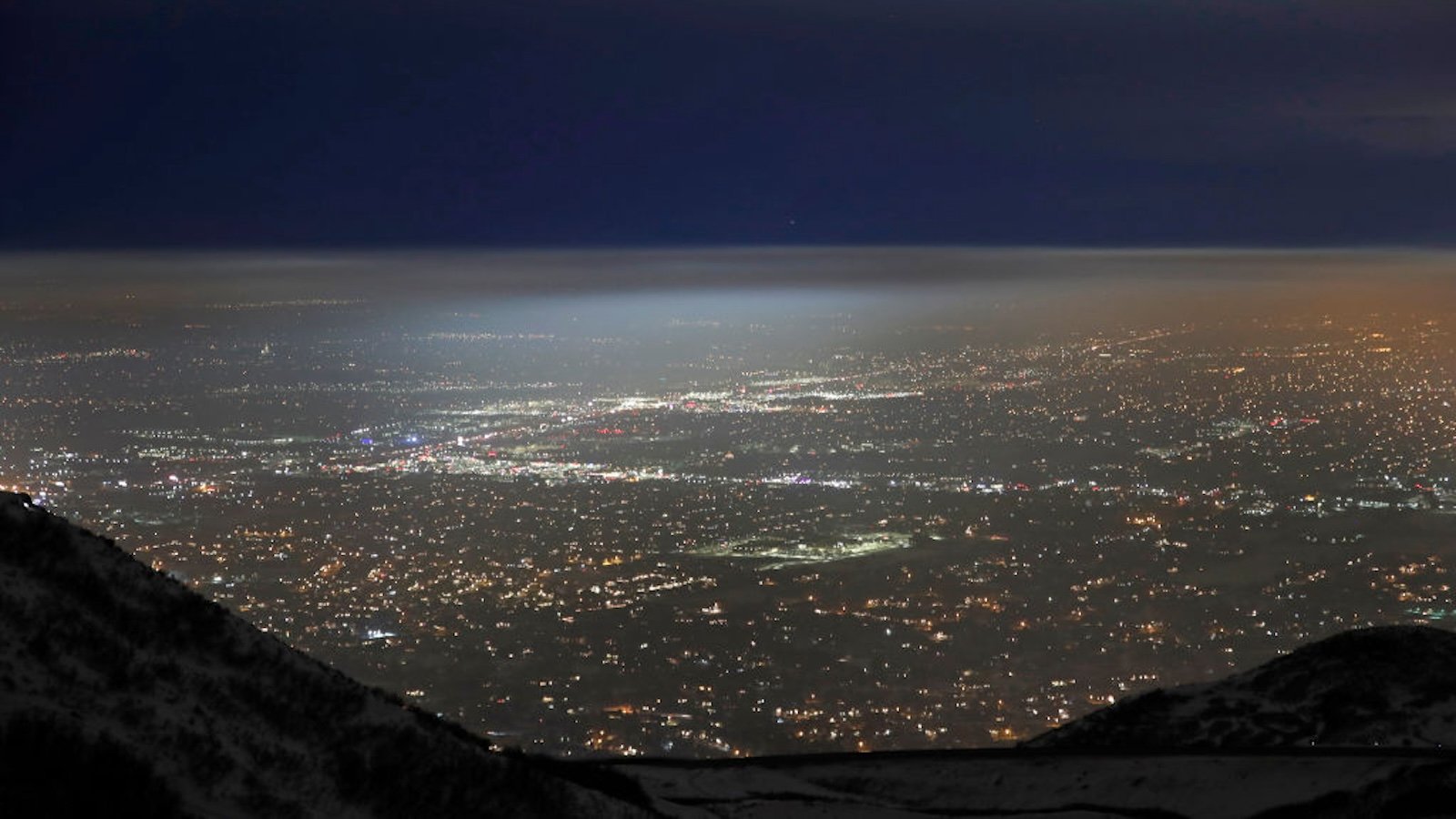 Salt Lake City valley at night time with a cloud of haze