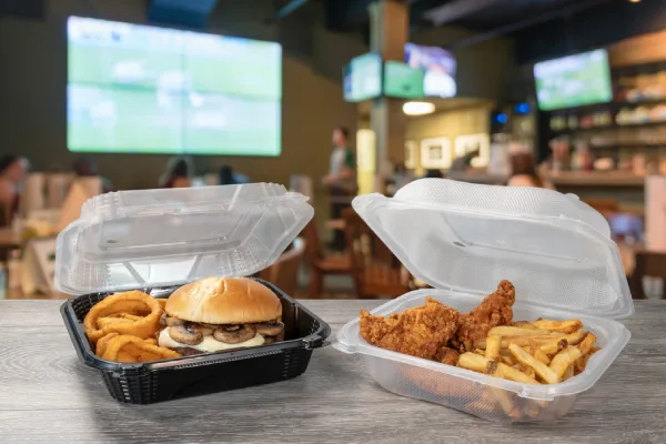 hinged food containers on counter at bistro