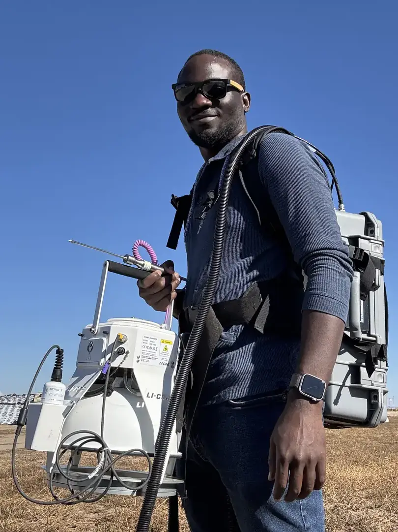 Gilbert Miito poses with a chamber with hoses attached.