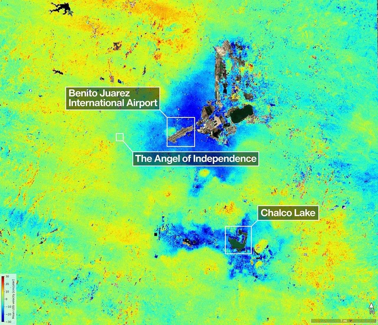 A satellite map of the Mexico City area shows land subsidence, with blue patches indicating the fastest rates of sinking compared to yellow and green patches. A color bar in the corner shows rate of change. The airport and a few landmarks are labeled.
