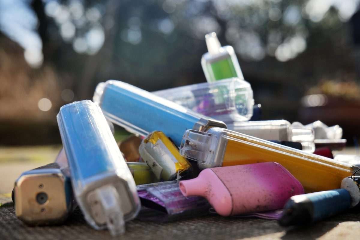 Pile of discarded disposable and rechargeable vapes