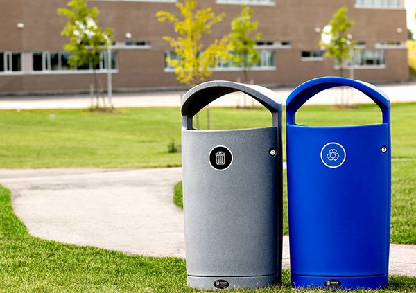 a set of outdoor recycling and trash bins