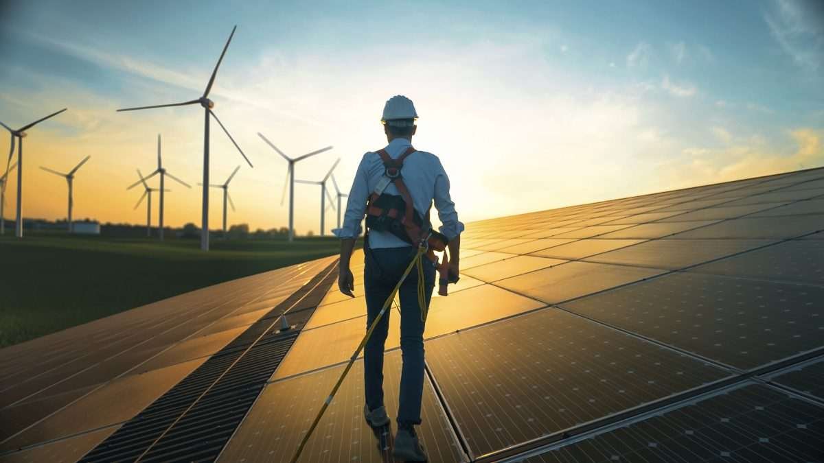 Renewable energy landscape and engineer walking through it