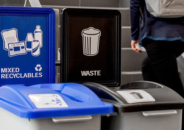 a set of recycling bins on a campus