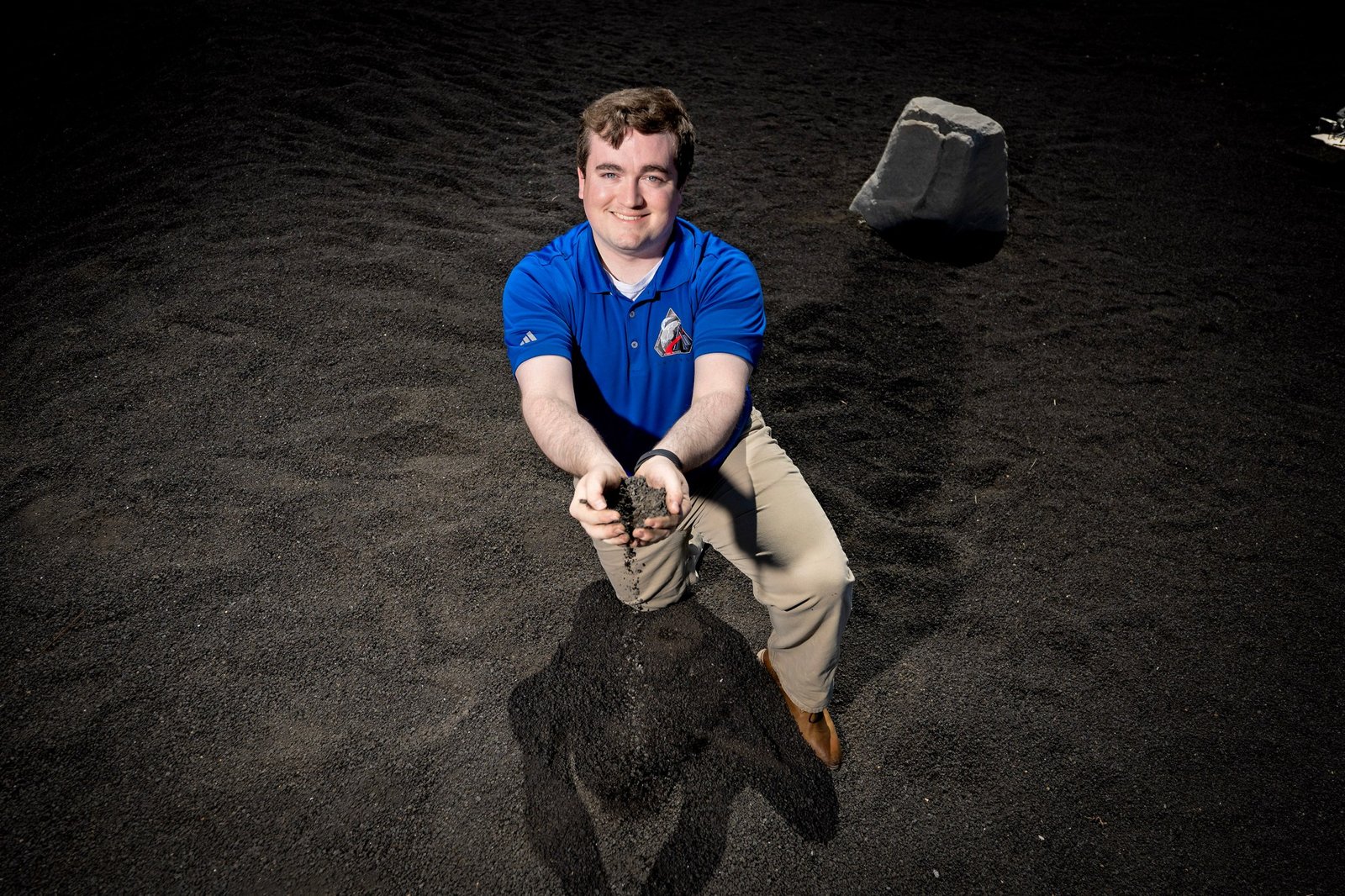 NASA’s Daniel Stubbs, seen here at the Lunar Regolith Terrain field at Marshall Space Flight Center, used his experience as a graduate student at in aerospace engineering at Auburn University modeling lunar regolith plumes into a position with NASA Marshall’s Plume and Aero Environments team working to characterize interactions between clouds of lunar regolith and commercial human landing systems.