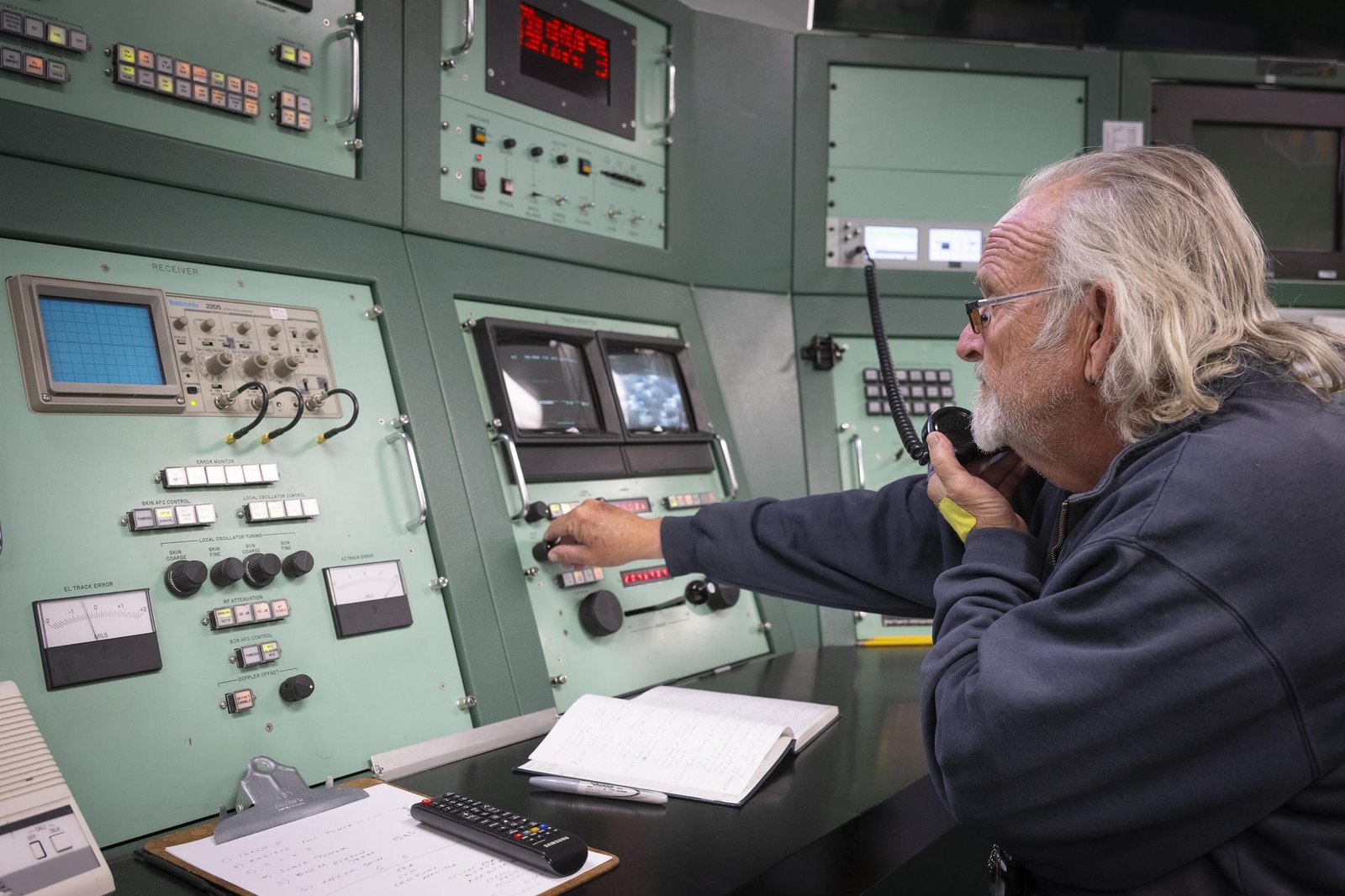 A man is on the phone at one of the radar stations used to track the International Space Station.