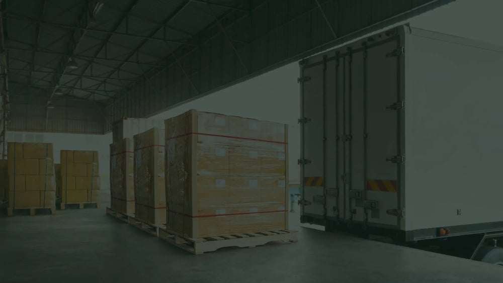 Hand pallet truck and the shipment pallet at the dock for loading into a truck
