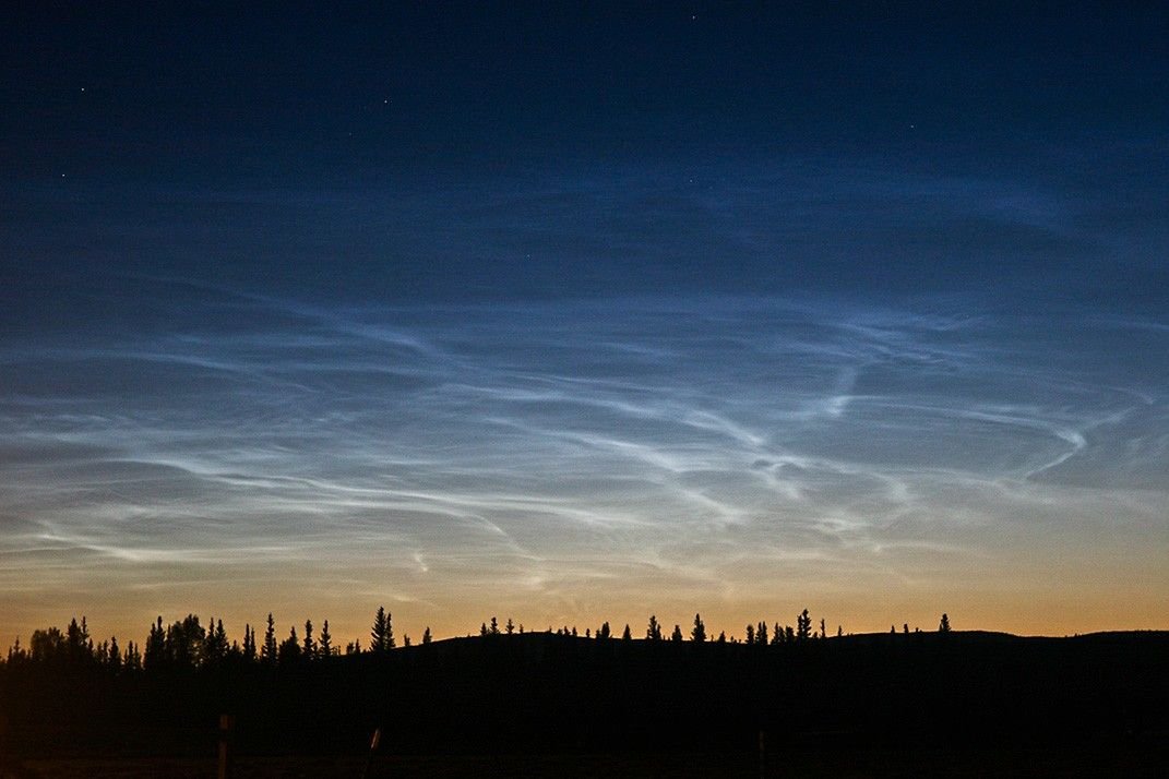Noctilucent clouds or "night-shining" clouds, are rare, electric-blue, wispy clouds formed of water ice crystals in the mesosphere, about 50 miles (80-85km) above Earth