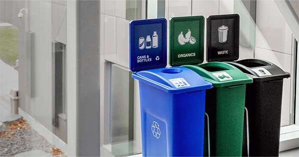 A set of recycling, trash, and compost bins