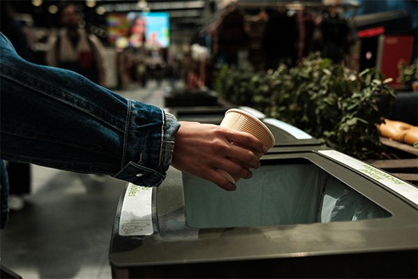 A person throwing away trash